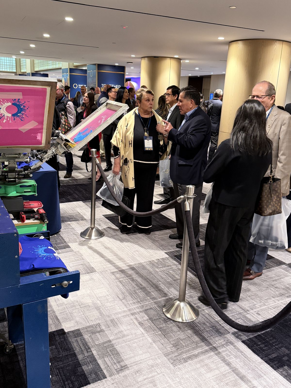 Guests in a stanchioned line watching the live station work at a hotel event